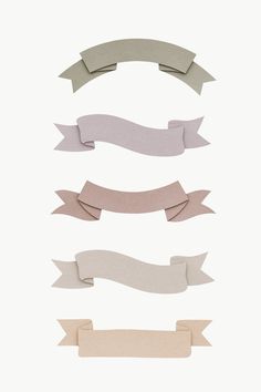 four ribbons with different shapes and sizes are shown on a white background in this image