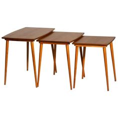 three wooden tables sitting next to each other