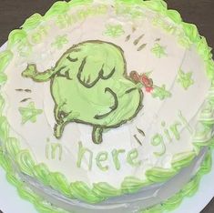 a green and white cake with the words in here going on it's frosting