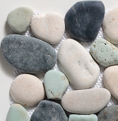 several different colored rocks laid on top of each other in a white background with a black and gray border