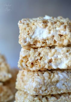 three rice krispy treats stacked on top of each other in front of another one