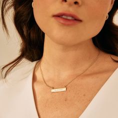 Commemorate a special memory with the Date Bar Necklace. This bar necklace will be custom engraved with your date of choice and is available in rose gold, yellow gold or rhodium-plated finishing options. A perfectly thoughtful gift for birthdays, anniversaries, and graduations. Available in 14k gold plated, rhodium plated or 14k rose gold plated brass Bar size: 1 1/4" by 1/4" 16" cable chain with 2" extender Lobster claw closure With engraving this item is FINAL SALE SKU: BYN1078 Personalized Bar Necklace For Anniversary, Elegant Engraved Text Jewelry, Minimalist Rose Gold Bar Necklace For Anniversary, Minimalist Anniversary Bar Necklace With Delicate Chain, Minimalist Bar Necklace With Delicate Chain For Anniversary, Minimalist Bar Necklace For Anniversary Or Mother's Day, Minimalist Delicate Chain Bar Necklace For Anniversary, Minimalist Custom Name Bar Necklace For Anniversary, Elegant Bar Necklace With Custom Name For Personalized Gift