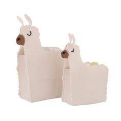 two white llamas standing next to each other in front of a white background