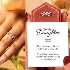 a woman's hand holding a card with a diamond ring on it, and the words to my daughter