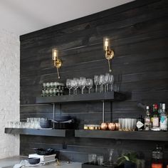 a bar with wine glasses and liquor bottles