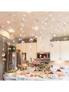 a kitchen filled with lots of food and bubbles hanging from the ceiling over the counter