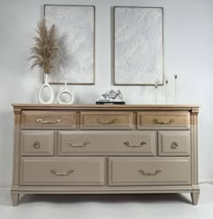 a dresser with two mirrors above it