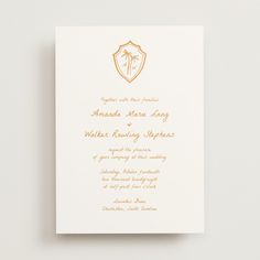 an elegant wedding card with gold foil and palm trees on the front, in white paper