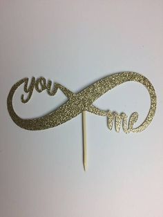 a cake topper with the word love spelled in gold glitter