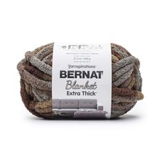 bernat blanket extra thick yarn in grey and brown colors on a white background with a tag