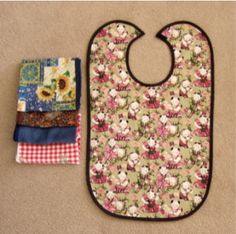 an oven mitt and pot holder are on the floor next to some cloths