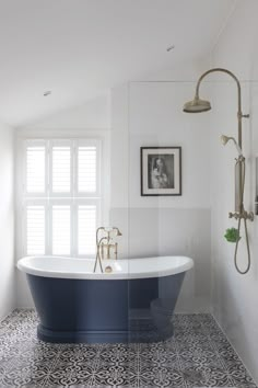 a bath tub sitting next to a window in a bathroom