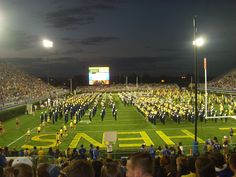 a band playing on a football field at night