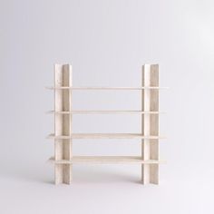 a white book shelf with four shelves on each side and one section missing from the top