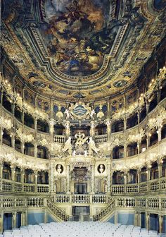 an ornately decorated auditorium with chandeliers and painted ceiling murals in paris, france