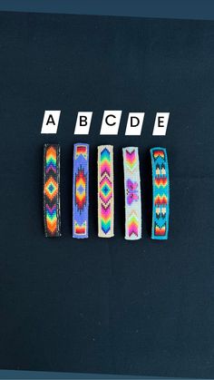 four bracelets with different designs on them sitting next to the word abcde written in white letters