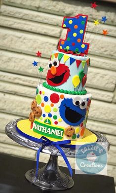 a birthday cake decorated with sesame street characters