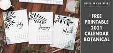 three printable calendars sitting on top of a wooden table