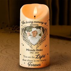 a memorial candle with an angel on it