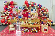 the table is set up with balloons, decorations and other items for a princess themed birthday party