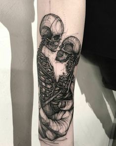 a man with a skeleton tattoo on his arm