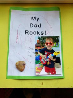 a sign that says, my dad rocks with a picture of a boy holding a guitar