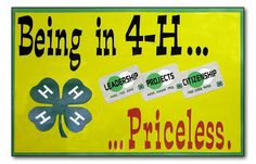 a yellow sign that says being in 4 h and has four clovers on it