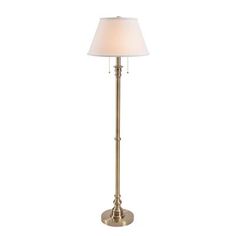 a floor lamp with a white shade on it