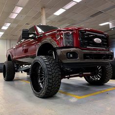 a large red truck parked in a garage