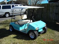 a blue golf cart parked in front of a house