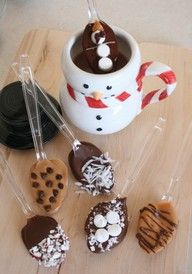 chocolate covered donuts and marshmallows in plastic wrappers on a wooden table