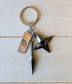 a metal keychain with a star shaped object attached to it