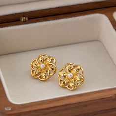 Introducing our stunning Hollow Flower Shaped Stud Earrings, meticulously crafted from durable stainless steel and elegantly adorned with an 18K gold plating. These earrings are a perfect blend of classic charm and modern sophistication, designed to add a touch of glamour to any ensemble. Whether you're attending a wedding, celebrating an anniversary, or simply dressing up for a gala, these earrings are sure to elevate your look. Key Features Material Excellence: Crafted from high-quality stainless steel, ensuring durability and longevity. Luxurious Finish: Enhanced with 18K gold plating for a radiant sheen that captures attention. Waterproof Design: Wear them confidently on any occasion without the fear of damage from water exposure. Hypoallergenic: Free from nickel, lead, and cadmium, ma Gold Plated Round Flower Earrings For Wedding, Gold Plated Flower Earrings For Weddings, Tarnish Resistant Gold Flower Earrings For Anniversary, Gold Tarnish-resistant Flower Earrings For Anniversary, Elegant Hypoallergenic Flower-shaped Earrings, Elegant Hypoallergenic Flower Shaped Earrings, Gold Hypoallergenic Flower Earrings For Anniversary, Hypoallergenic Gold Flower Earrings For Anniversary, Tarnish Resistant Gold Plated Flower Earrings