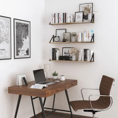 a desk with a laptop on it next to two shelves