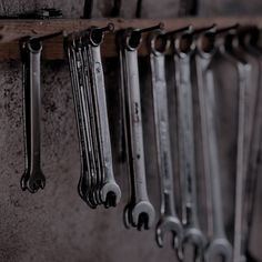 there are many wrenches hanging on the wall