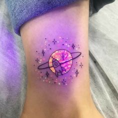 a woman's foot with a small tattoo on it that has an image of a space shuttle flying through the sky