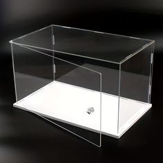 a clear box with a screw in it on a black surface, showing the inside