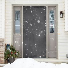 a front door covered in snow next to a house