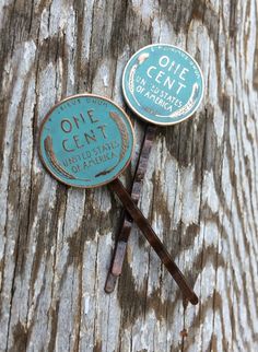 two pins with the words one cent on them