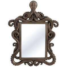 an ornate mirror with an octopus design on the front and bottom frame, is shown