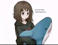 a girl is holding a stuffed shark in her arms with the caption only the shark understands me