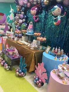 an under the sea themed birthday party with balloons, cake and desserts on tables