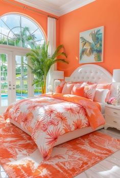 an orange and white bedroom with palm trees in the window sill, bedding, and rugs