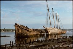 an old boat sitting on top of a wooden dock