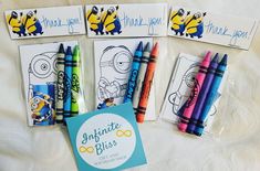 three minion thank you note cards and four crayon pens on a bed