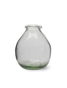 an empty glass vase sitting on top of a white surface