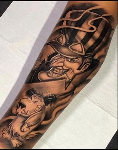 a man's arm with tattoos on it and an image of a dog wearing a top hat