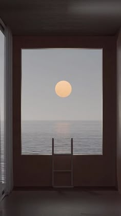 the sun is setting over the ocean from an empty room with a ladder in front of it