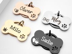 four different dog tags with names on them