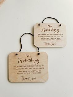 two wooden plaques with the words, no solicing and thank you are offering us